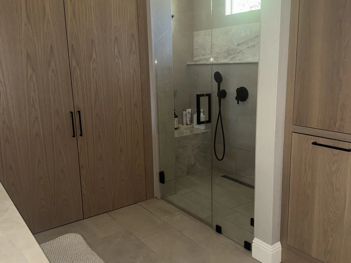 Cleaned bathroom with glass shower and wood vanity