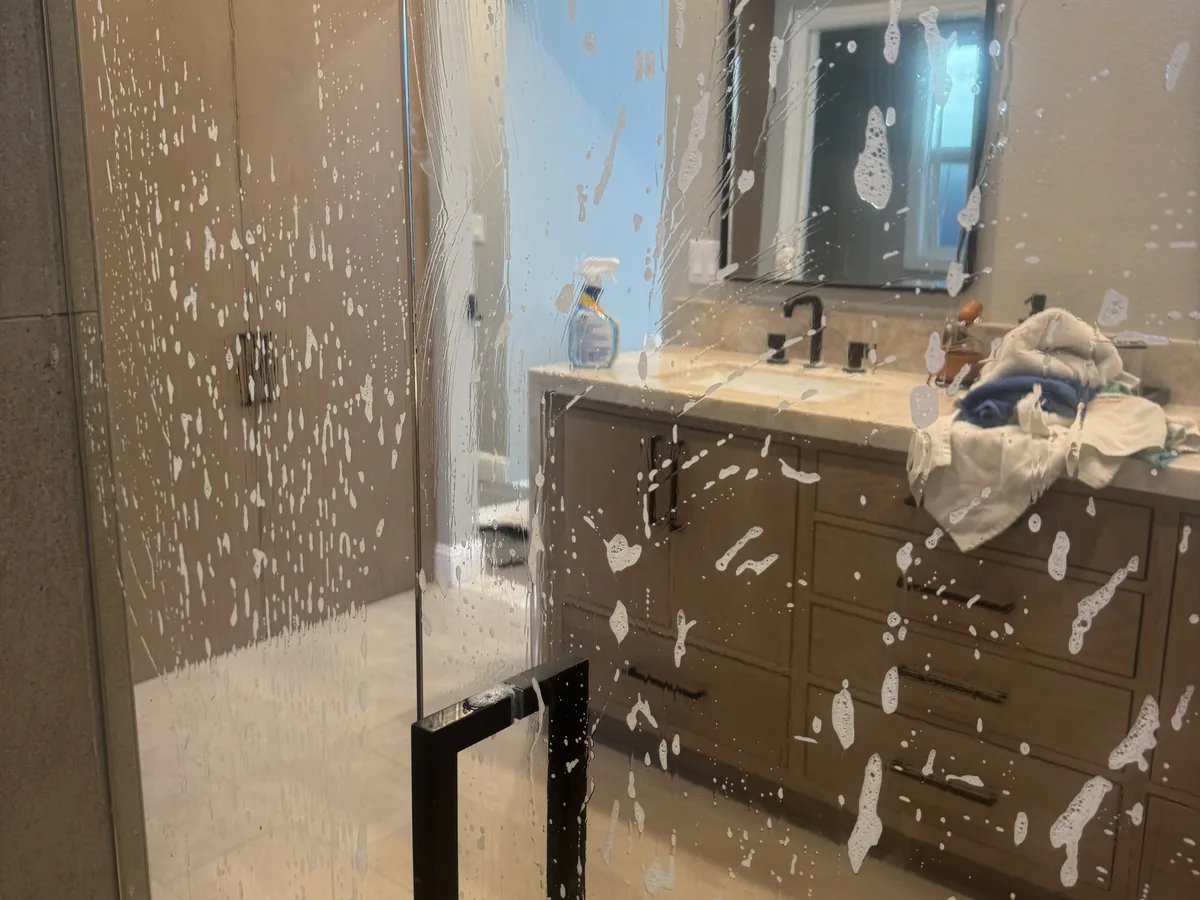 Foaming cleaner applied to a glass shower door