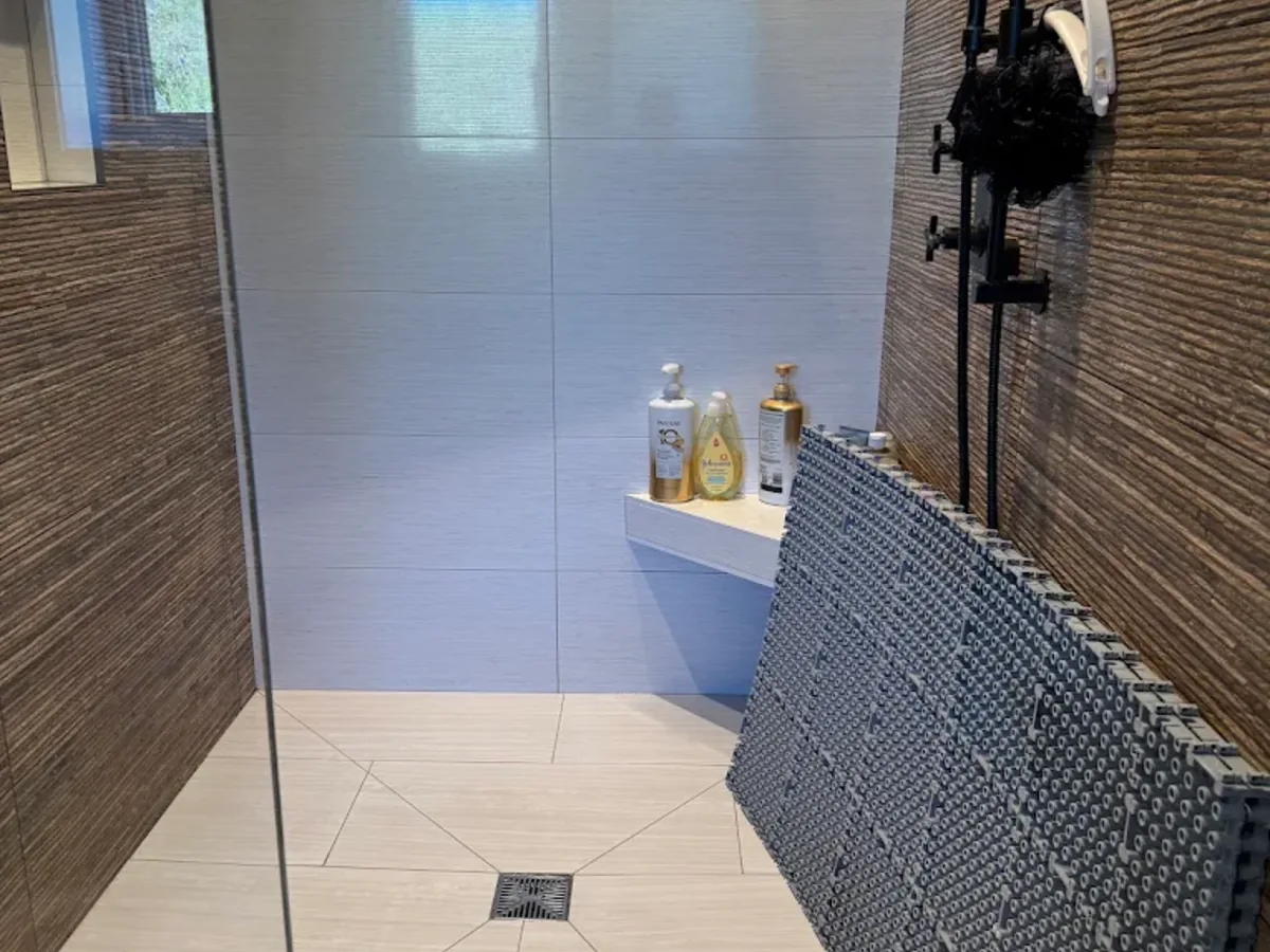 Deep cleaned tile shower with black fixtures
